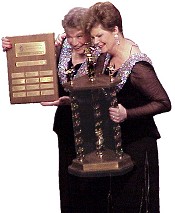 Peggy Gram (Director) and Donna Nilson (Team Coordinator) carry the hardware for the Top of the Rock Chorus.
